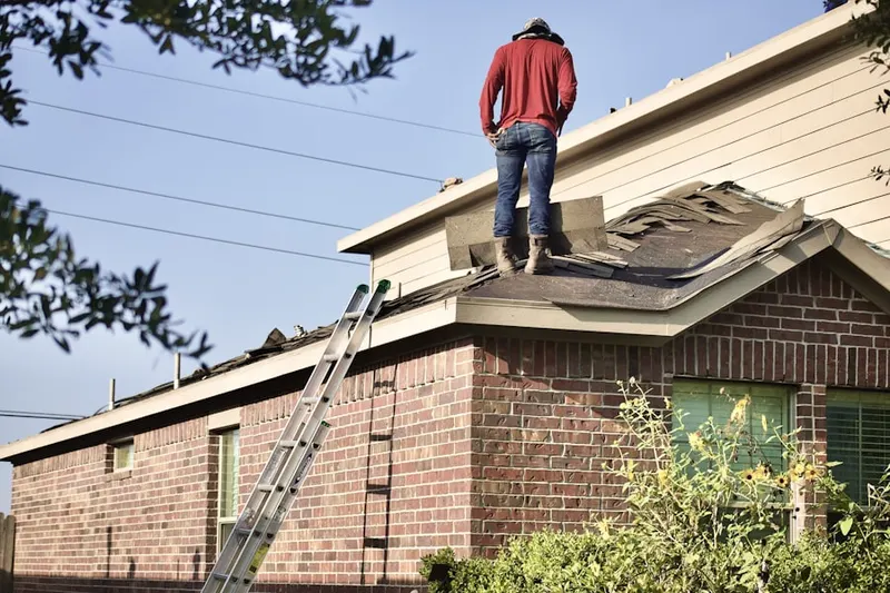 Professional roofer working on a residential roof in New Hyde Park